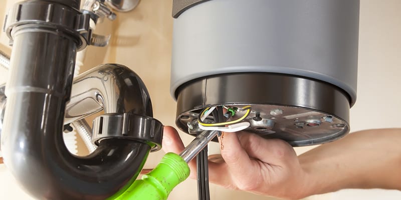 Titusville, Florida plumber servicing water heater pipe connection