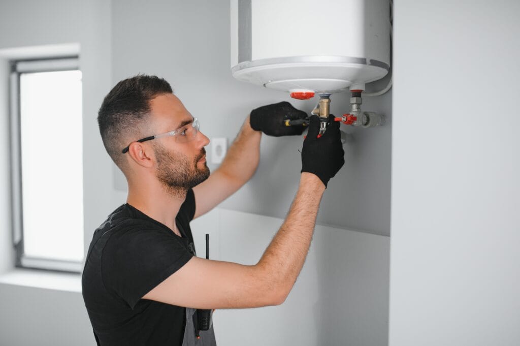 Technician performing water heater maintenance in Titusville