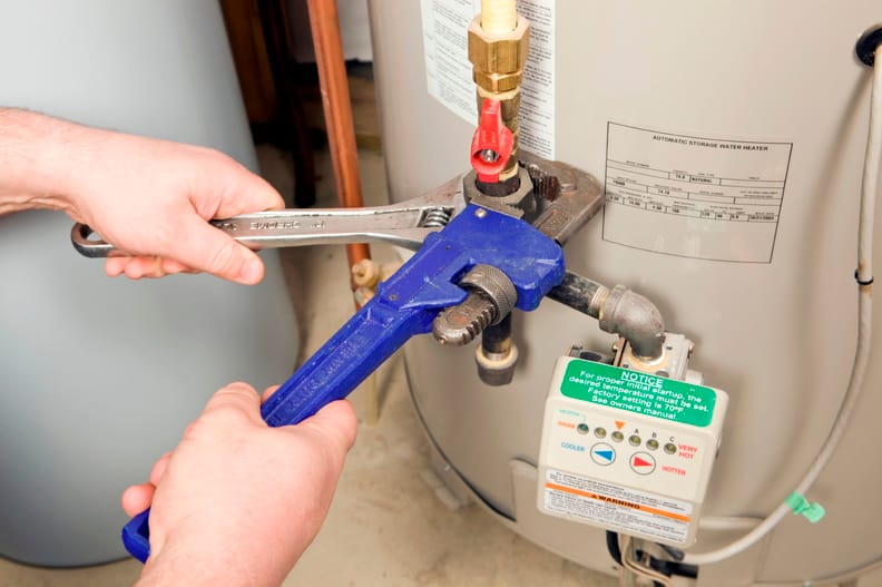 Plumber repairing a water heater valve in Titusville